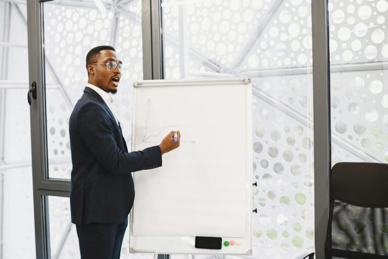 Businessman presenting on a flip chart in a contemporary office setting.